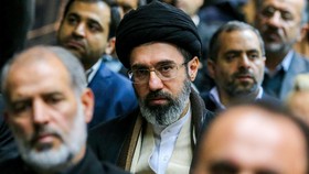 In this picture obtained from Iran's ISNA news agency, Mojtaba Khamenei (C), son of Iran's supreme leader Ayatollah Ali Khamenei, looks on during a gathering in Tehran on July 18, 2016. (Photo by AMIR KHOLOUSI / ISNA / AFP)