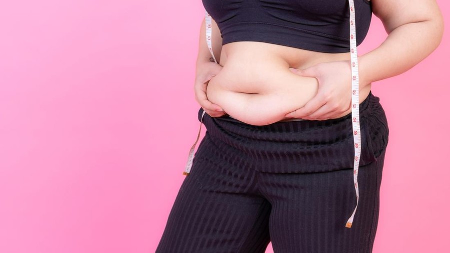 asian fat women &comma; Fat girl &comma; Chubby&comma; overweight squeeze belly fat with measure tape on her neck - Woman diet lifestyle overweight problem concept