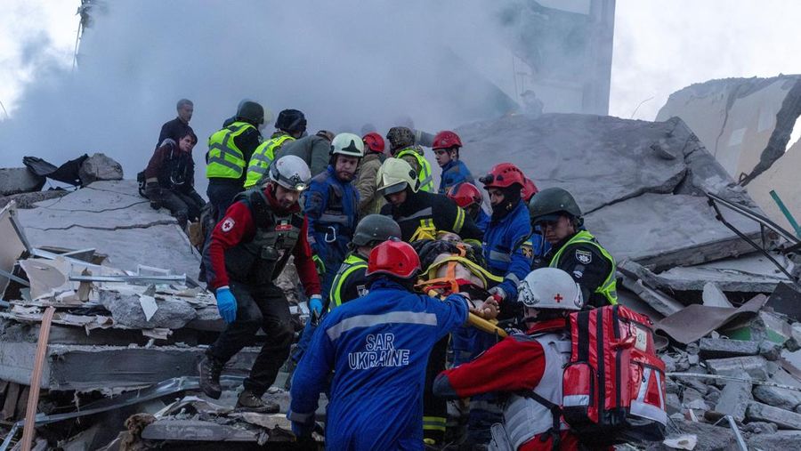 Para penyelamat membawa jenazah nan ditemukan dari bawah reruntuhan di letak gedung apartemen nan rusak akibat serangan rudal di Kyiv, Ukraina, Jumat (15/5/2026). (via REUTERS/STATE EMERGENCY SERVICE OF UKRAI)