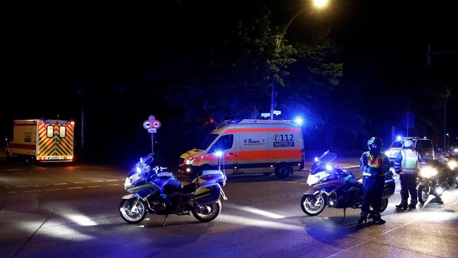 A convoy with an ambulance believed to be carrying an American health worker, who has been brought to Germany for treatment after contracting Ebola in the Democratic Republic of Congo, arrives at the Charite University Hospital in Berlin, Germany, Ma