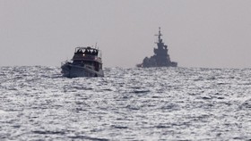 Israeli soldiers are seen on a vessel bearing symbols of the Global Sumud Flotilla, with an Israeli military ship behind it, as seen from Ashdod, southern Israel, May 19, 2026. REUTERS/Amir Cohen     TPX IMAGES OF THE DAY