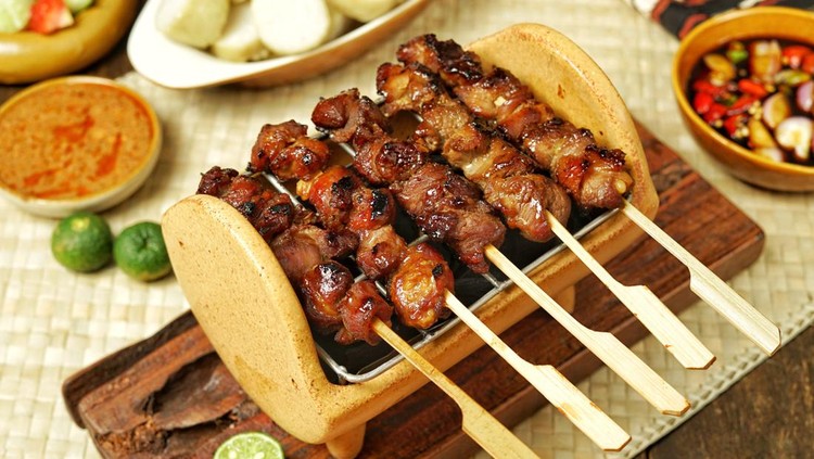 Sate Kambing or Goat satay&comma; typical of Central Java&comma; Indonesia&period; Diced mutton skewered on a bamboo skewer&period; Served with rice cake&comma; soy sauce and peanut sauce&period; Usually served during Eid al-Adha&period;