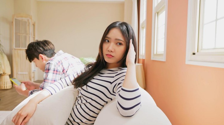 technology and relationship problem concept - Asian man addicts social network media or video games and ignore couple relationship at home while woman is annoyed about their communication problems