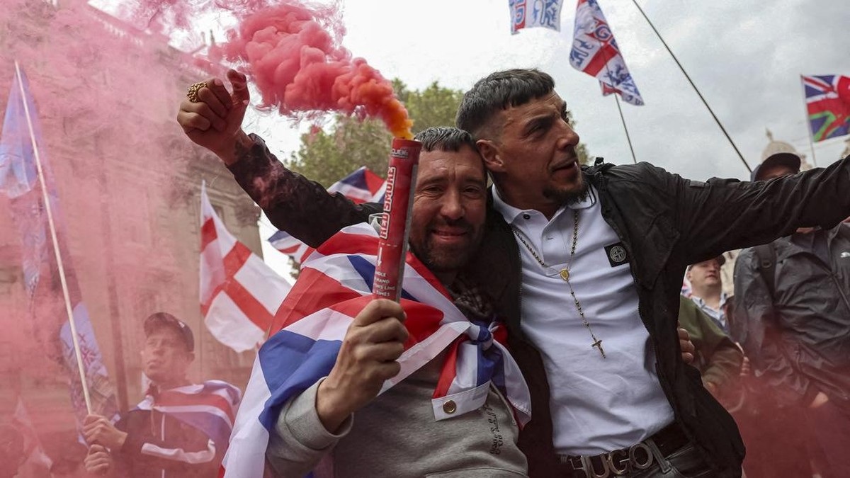 A protester holds a smoke flare as he takes part in a