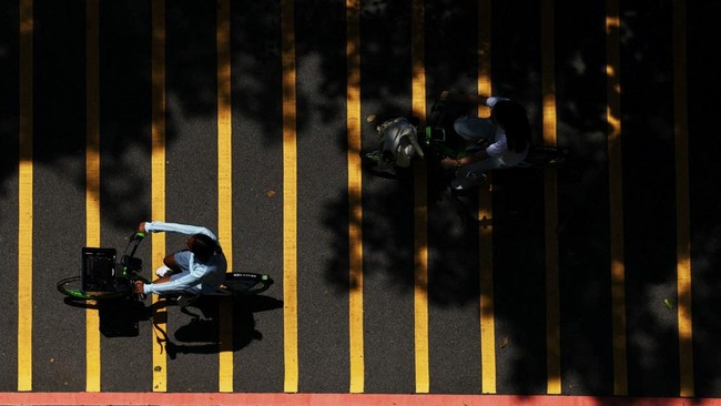 People ride bicycles at a park in northeastern Singapore May 19, 2026. REUTERS/Edgar Su
