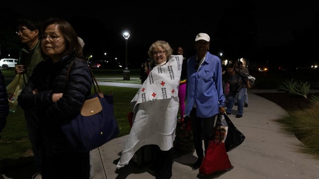 Nancy O'Leary stands in line to register at a temporary shelter in Fountain Valley, California, following evacuations prompted by a failing chemical tank containing methyl methacrylate, a flammable liquid used in the aerospace industry, in nearby Gar
