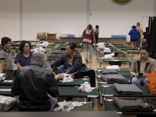 Residents sit at a temporary shelter in Fountain Valley, California, following evacuations prompted by a failing chemical tank containing methyl methacrylate, a flammable liquid used in the aerospace industry, in nearby Garden Grove, California, U.S.