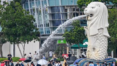 People visit the Merlion statue on the Marina Bay waterfront in Singapore on May 5, 2026. (Photo by Roslan RAHMAN / AFP)
