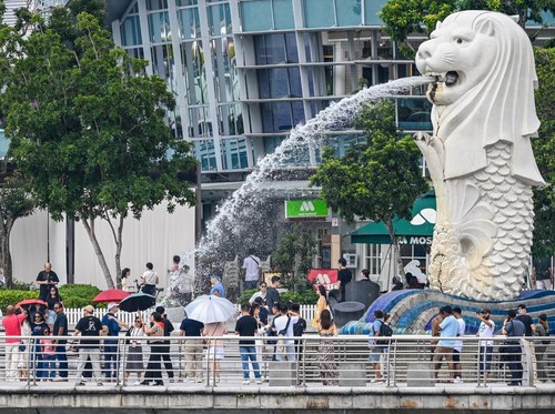People visit the Merlion statue on the Marina Bay waterfront in Singapore on May 5, 2026. (Photo by Roslan RAHMAN / AFP)