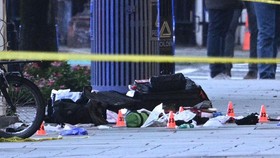 Police tape blocks off a crime scene with evidence markers seen on a sidewalk on 17th and Pennsylvania Ave near the White House in Washington, DC, on May 23, 2026. Police and security forces swarmed the area around the White House on the evening of M