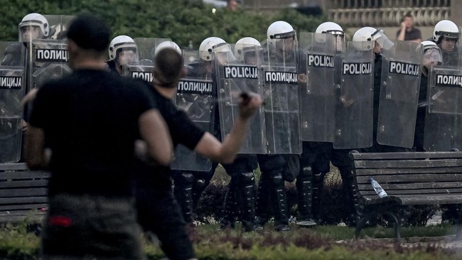 Riot police chase demonstrators during sporadic clashes that erupt at the end of an anti-government protest decrying corruption and calling for early elections following the collapse of a railway station canopy in Novi Sad that killed 16 in November