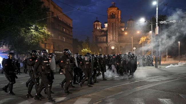 Riot police chase demonstrators during sporadic clashes that erupt at the end of an anti-government protest decrying corruption and calling for early elections following the collapse of a railway station canopy in Novi Sad that killed 16 in November