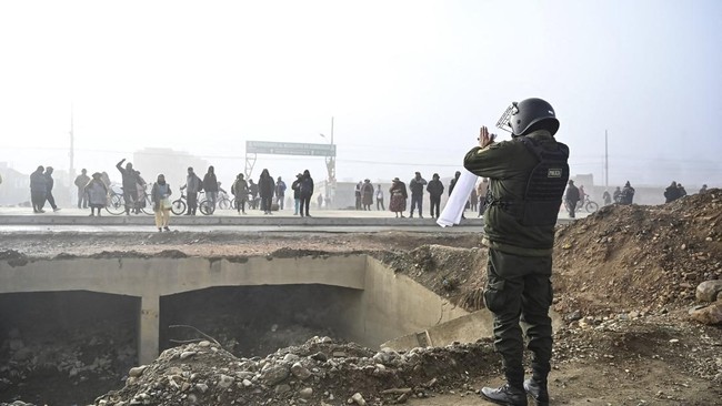 A security member gestures while trying to open