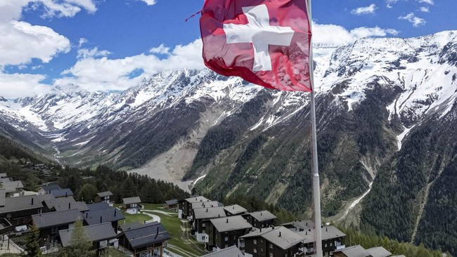 A drone view shows the village of Wiler, overlooking the landslide area nearly a year after a massive rock and ice slide triggered by the collapse of the Birch Glacier destroyed much of the village of Blatten, Switzerland, May 13, 2026. REUTERS/Denis