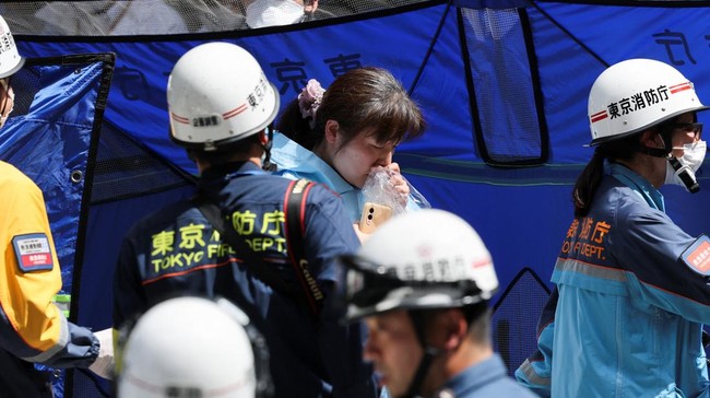 Emergency services workers evacuate a woman from the Ginza Six shopping complex, after an irritant was sprayed by an unknown person, in Tokyo, Japan May 25, 2026. REUTERS/Issei Kato