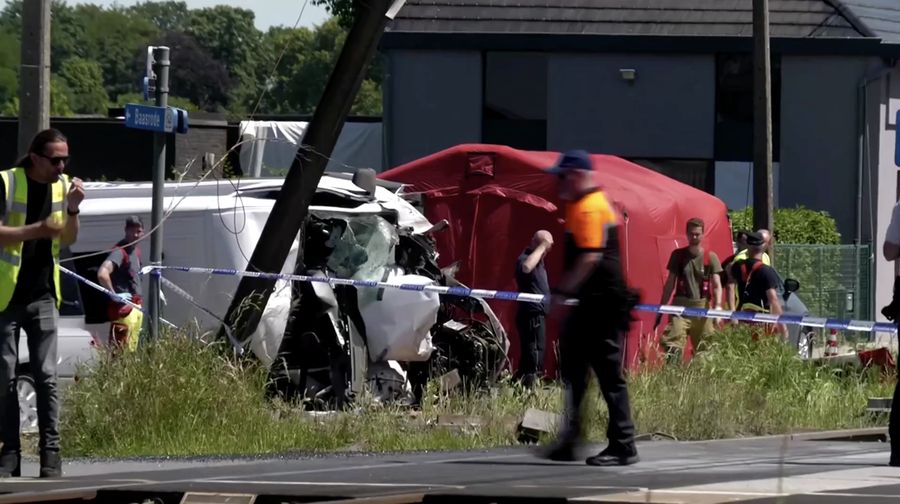 Tim penyelamat memandang bus sekolah nan rusak usai tertabrak kereta di sebuah perlintasan rel di wilayah Flanders utara, Beglia Selasa (26/5/2026) pagi waktu setempat. (Tangkapan Layar Video Reuters/)