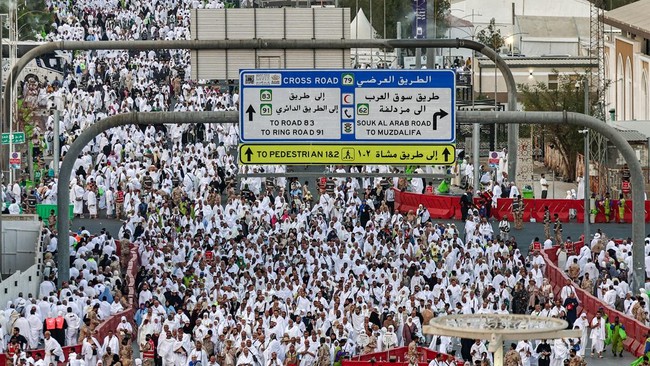 Muslim pilgrims pray near Saudi Arabia's Mount Arafat, also known as Jabal al-Rahma or Mount of Mercy, during the climax of the Hajj pilgrimage early on May 26, 2026.