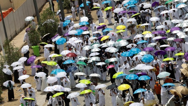 Muslim pilgrims use umbrellas to shield themselves from the sun after noon prayers outside Nimrah Mosque at the Plain of Arafat during the annual hajj pilgrimage. REUTERS/Ibraheem Abu Mustaf