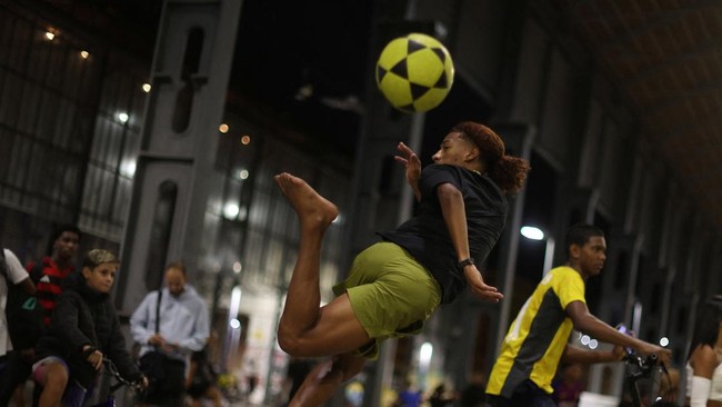 People play altinha, a Brazilian game where players gather to keep a ball in the air without using their hands, outside the Nilton Santos stadium in Rio de Janeiro, Brazil April 13, 2026. REUTERS/Pilar Olivares