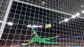 Paris Saint-Germain's Russian goalkeeper #39 Matvey Safonov dives as Arsenal's Brazilian defender #06 Gabriel Magalhaes misses the last penalty of the penalty shootout during the UEFA Champions League final football match between Paris Saint-Germain
