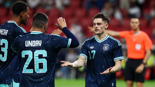 Soccer Football - International Friendly - Germany v Finland - MEWA Arena, Mainz, Germany - May 31, 2026 Germany's Florian Wirtz celebrates scoring their second goal with Felix Nmecha and Deniz Undav REUTERS/Kai Pfaffenbach
