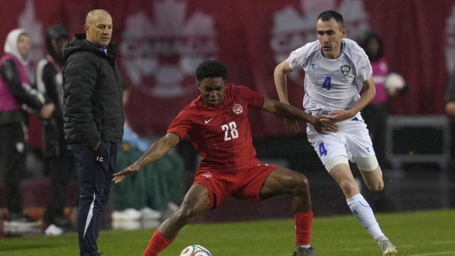 EDMONTON, ALBERTA - JUNE 01: Ralph Priso-Mbongue of Canada competes for the ball with Farrukh Sayfiev of Uzbekistan during the international friendly match between Canada and Uzbekistan at Commonwealth Stadium on June 01, 2026 in Edmonton, Alberta.