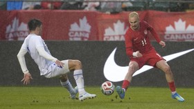EDMONTON, ALBERTA - JUNE 01: Liam Millar of Canada dribbles the ball against Abdukodir Khusanov of Uzbekistan during the international friendly match between Canada and Uzbekistan at Commonwealth Stadium on June 01, 2026 in Edmonton, Alberta.   Jeff