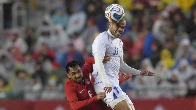 EDMONTON, ALBERTA - JUNE 01: Oston Urunov of Uzbekistan heads the ball against Mathieu Choiniere of Canada during the international friendly match between Canada and Uzbekistan at Commonwealth Stadium on June 01, 2026 in Edmonton, Alberta.   Jeff Vin