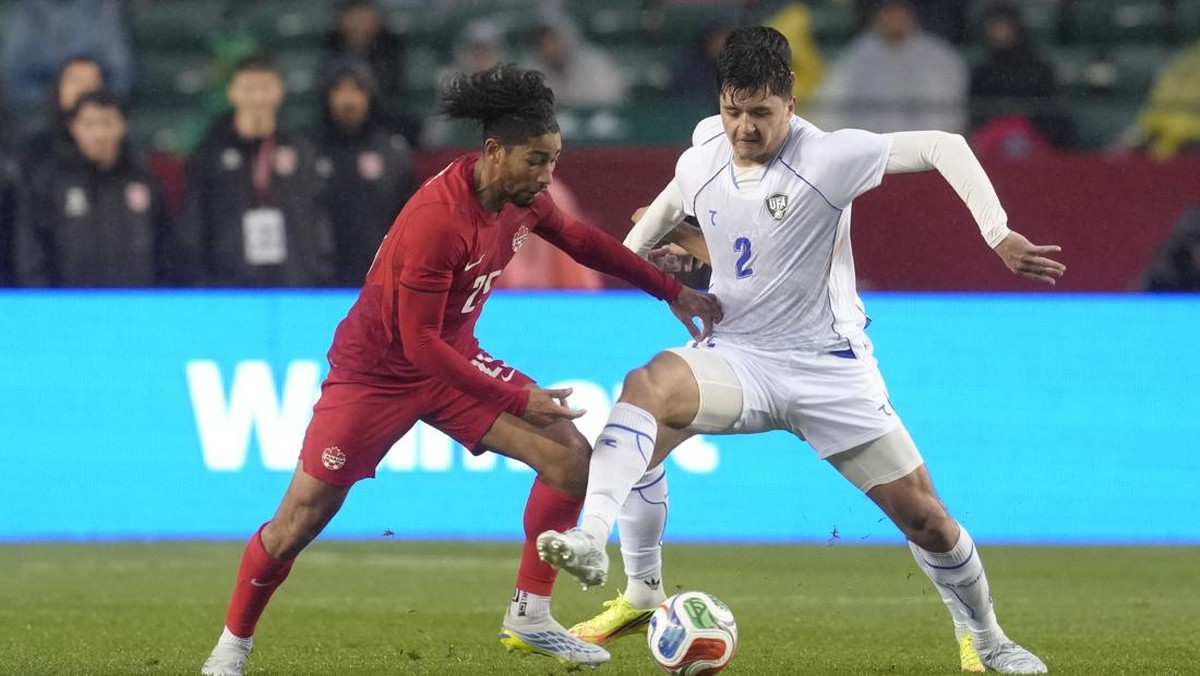 EDMONTON, ALBERTA - JUNE 01: Abdukodir Khusanov of Uzbekistan competes for the ball with Nathan Saliba of Canada during the international friendly match between Canada and Uzbekistan at Commonwealth Stadium on June 01, 2026 in Edmonton, Alberta.   Je