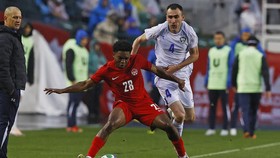Jun 1, 2026; Edmonton, Ontario, CAN; Team Canada defender Ralph Priso (28) and Uzbekistan defender Farrukh Sayfeiv (4) battle for a loose ball during the second half at Commonwealth Stadium. Mandatory Credit: Perry Nelson-Imagn Images