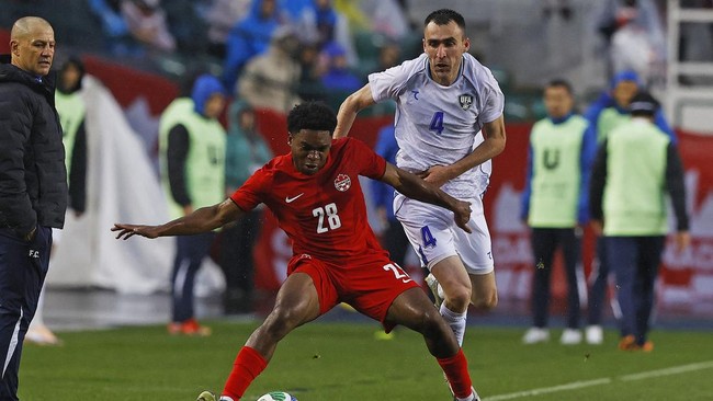 Jun 1, 2026; Edmonton, Ontario, CAN; Team Canada defender Ralph Priso (28) and Uzbekistan defender Farrukh Sayfeiv (4) battle for a loose ball during the second half at Commonwealth Stadium. Mandatory Credit: Perry Nelson-Imagn Images