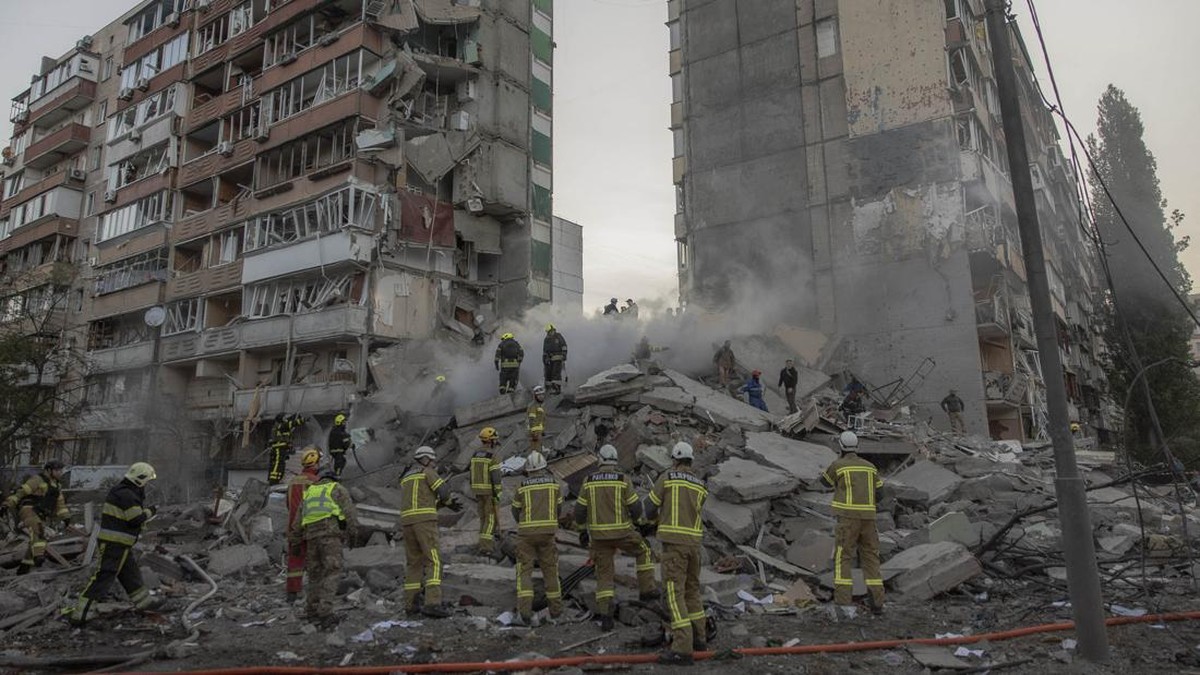 Rescuers work at a residential building partially destroyed following Russian drone and missile strikes in Kyiv on May 14, 2026, amid the Russian invasion in Ukraine. Ukraine's capital came under heavy aerial attack early on May 14, an AFP journalist
