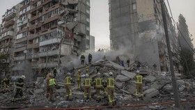 Rescuers work at a residential building partially destroyed following Russian drone and missile strikes in Kyiv on May 14, 2026, amid the Russian invasion in Ukraine. Ukraine's capital came under heavy aerial attack early on May 14, an AFP journalist