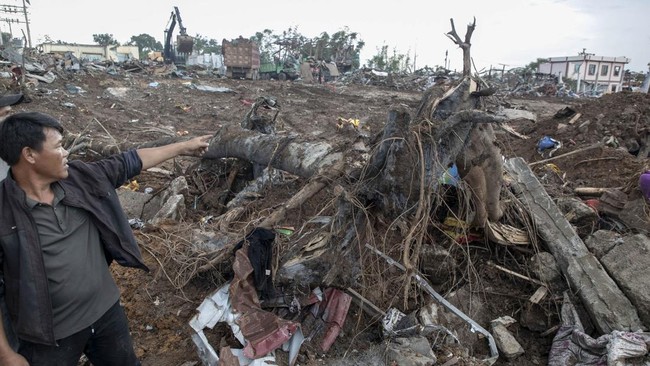 A man points over the debris following an explosion in Kaung Tat village, in Namhkam Township in Myanmar's Shan state on June 1, 2026. A blast in northern Myanmar killed dozens of people on May 31, two rescue workers said, with rebels controlling the
