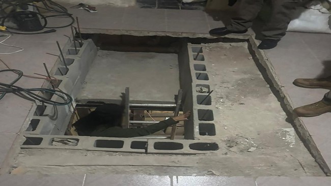 This handout picture released by Mexico's Secretariat of Security and Citizen Protection on June 1, 2026, shows the entrance to an underground tunnel connecting Mexico and the United States discovered by the Criminal Investigation Agency (AIC) in Tij