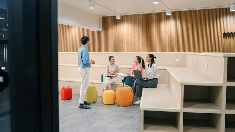 Team brainstorming session in a contemporary office&comma; showcasing casual collaboration&comma; creativity&comma; and productivity among young multicultural professionals&period;