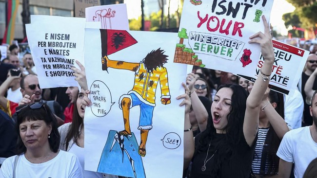 Protesters hold banners during a protest against a luxury resort development planned by a company linked with Donald Trump's son-in-law, Jared Kushner, on an environmentally sensitive part of the Adriatic coast, in Tirana, Albania, June 4, 2026. REUT