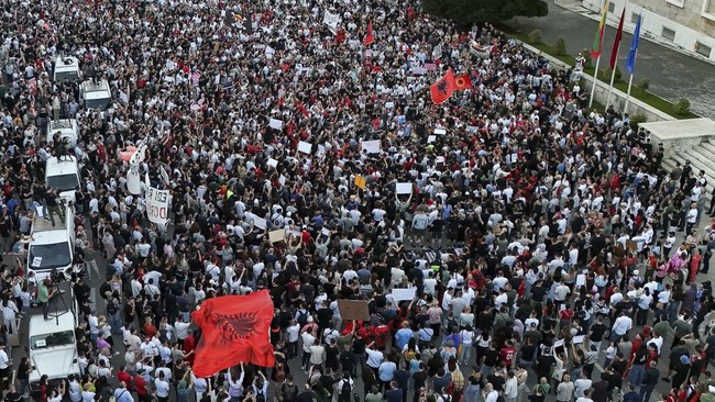 A drone view shows demonstrators holding banners during a protest against a luxury resort development planned by a company linked with Donald Trump's son-in-law, Jared Kushner, on an environmentally sensitive part of the Adriatic coast, in Tirana, Al