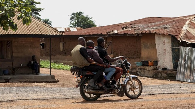 Local hunters from the community ride a motorcycle in the Yawota community, where dozens of pupils and teachers were abducted in a large-scale school attack, in Oyo State, Nigeria, June 2, 2026. REUTERS/Sodiq Adelakun