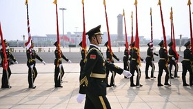 Chinese People's Liberation Army (PLA) honour guard march in front of the Great Hall of the People ahead of a welcome ceremony for US President Donald Trump in Beijing on May 14, 2026. (Photo by Brendan SMIALOWSKI / AFP)