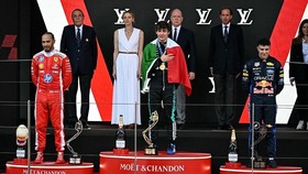 (From L) Second-placed Ferrari's British driver Lewis Hamilton, first-placed Mercedes' Italian driver Kimi Antonelli and third-placed Red Bull Racing's French driver Isaac Hadjar celebrate on the podium after competing in Monaco Formula 1 Grand Prix