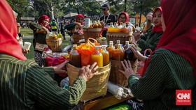 Sejumlah acaraki meyiapkan jamu gratis di Acaraki Jamu Festival di Hutan Kota Senayan, Jakarta Selatan, Minggu (7/6). (CNN Indonesia/Febria Adha L)