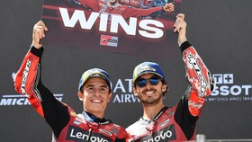 Winner Team Ducati Lenovo Team's Marc Marquez (L) and third placed Team Ducati Lenovo Team's Francesco Bagnaia celebrate with a sign to mark Marquez' 100-win mark on the podium of the Hungarian Motorcycle MotoGP Grand Prix at the Balaton Park circuit