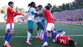 Soccer Football - International Friendly - Portugal v Chile - Estadio Nacional do Jamor, Lisbon, Portugal - June 6, 2026 Portugal's Rafael Leao, Bruno Fernandes and Renato Veiga clash with Chile's Francisco Sierralta and Felipe Loyola as Ivan Roman r