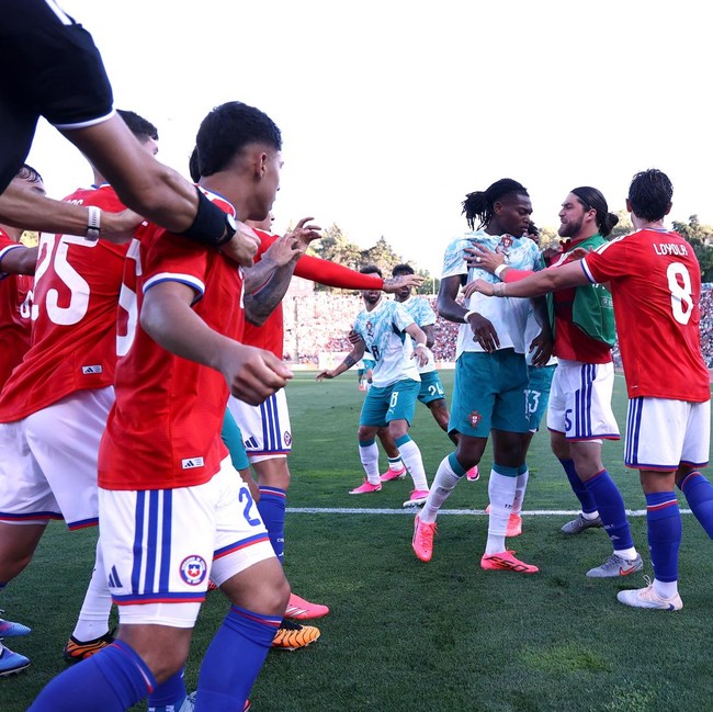 Soccer Football - International Friendly - Portugal v Chile - Estadio Nacional do Jamor, Lisbon, Portugal - June 6, 2026 Portugal's Rafael Leao and Chile's Francisco Sierralta clash as Ivan Roman reacts REUTERS/Rodrigo Antunes