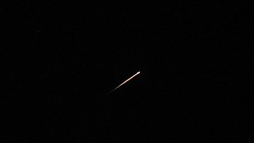 A streak of light illuminates the sky during a missile attack from Iran towards Israel, as seen from Jerusalem, June 7, 2026. REUTERS/Ammar Awad