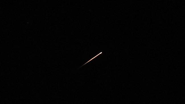 A streak of light illuminates the sky during a missile attack from Iran towards Israel, as seen from Jerusalem, June 7, 2026. REUTERS/Ammar Awad