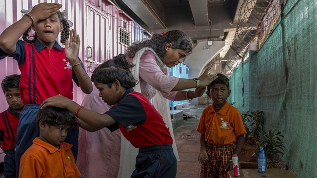 This photograph taken on May 18, 2026 shows children getting ready after arriving at the