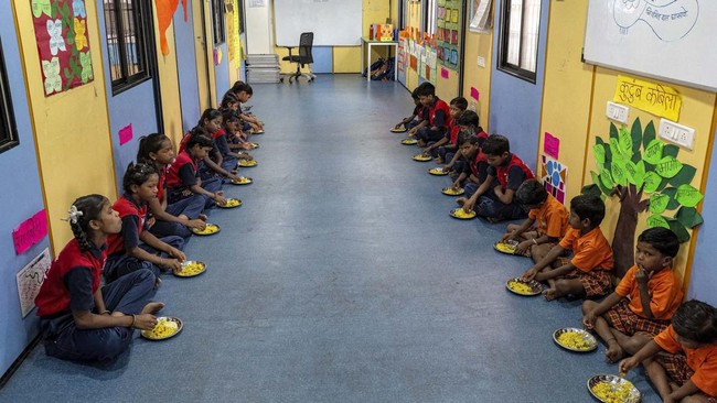 This photograph taken on May 18, 2026 shows children having their breakfast at the