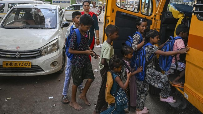 This photograph taken on May 25, 2026 shows children boarding the